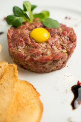 Raw beef tartare served with thin crispy croutons and balsamic sauce