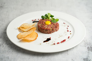 Raw beef tartare served with thin crispy croutons and balsamic sauce
