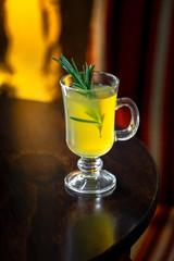 Cocktail with rosemary standing on the table in the restaurant