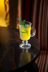 Cocktail with rosemary standing on the table in the restaurant