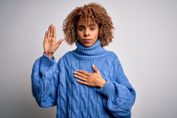 Young beautiful african american woman wearing turtleneck sweater over white background Swearing...
