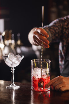 bartender is preparing classic manhattan cocktail