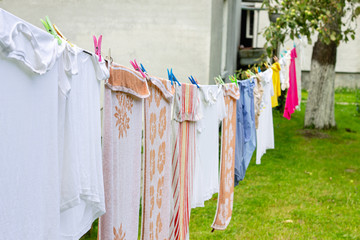 Colorful laundry hanging on rope in summer garden in typical countryside village