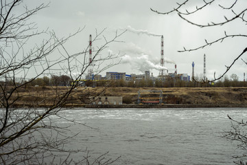 
industrial landscape with city river and industrial pipes