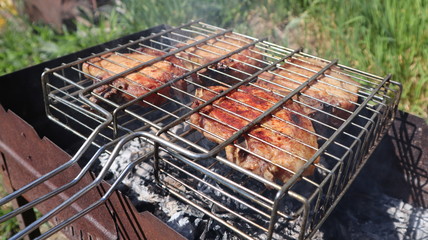 Pork steaks cooked on a charcoal grill outdoors