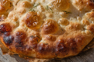 Appetizing, crispy, yeastless focaccia. Italian traditional bread. Made with natural bread sourdough