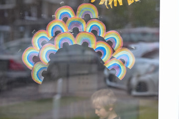 Rainbows are stuck to window by children to show gratitude and support for healthcare workers in the community