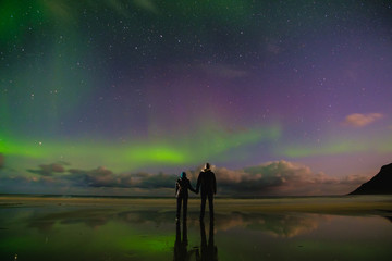 people on the beach and aurora in norway, lofoten islands - obrazy, fototapety, plakaty