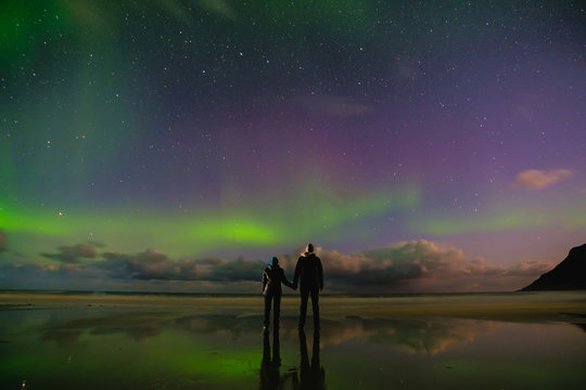 People On The Beach And Aurora In Norway, Lofoten Islands