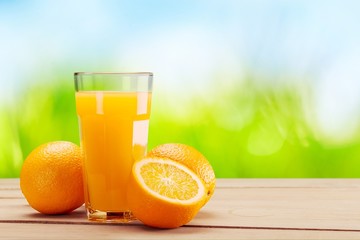 Orange juice in glass and slices of orange fruit