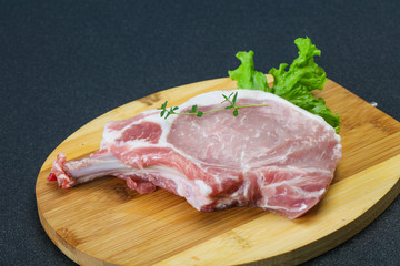 Raw pork bone steak over wooden