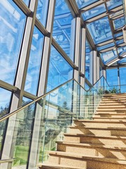 Interior glass walls and roofs of a modern building with stairs