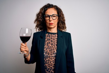 Middle age brunette woman drinking glass of red wine over isolated white background with a...