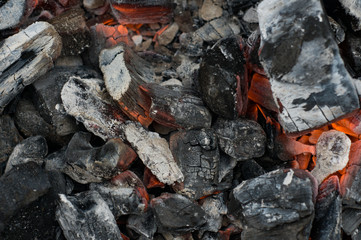 Smoldering black embers. Natural background. Grilling concept. Burnt wood. Fireplace. Fire. Ashes in fire pit