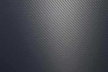 Close up of grey diagonal oriented woven carbon fibre sheet surface.