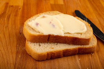 Sandwich with melted cheese on a wooden cutting Board. Close up.