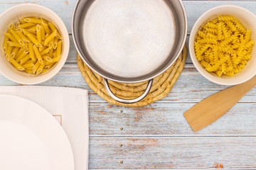 Various kind of pasta served on table with cutlery