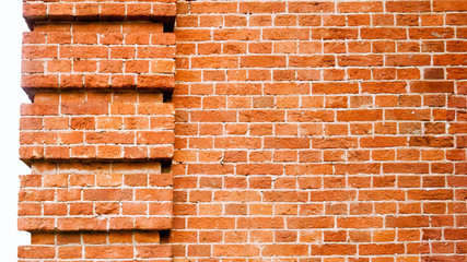 Three- dimensional elements of brickwork on the wall. Terraces on an old brick wall. Old weathered red brick.