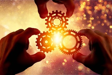 Hands holding three gear wheel