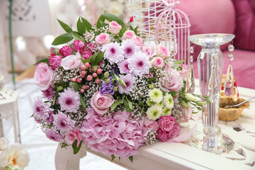 Beautiful bouquet of colored roses wrap bulurred background . Multi-colored flower bouquet .