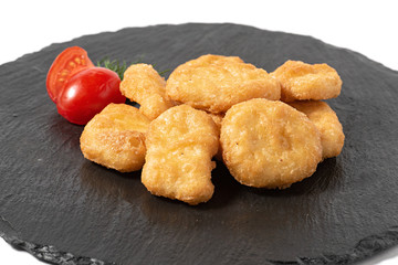 chicken nuggets on a board on a white background