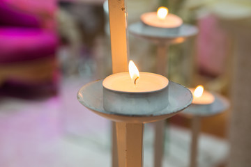 votive candles in iron candlestick . vintage wrought iron candle holders .