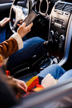 Hand with modern smartphone in the car stock photo