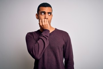 Young handsome african american man wearing casual sweater over white background looking stressed...