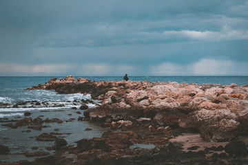 Fisherman On The Rocks