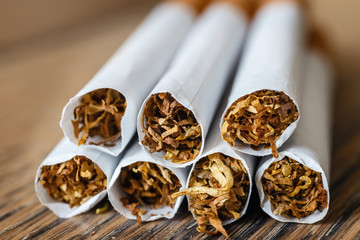Close up of a hndmade smoking cigarettes on wooden background
