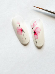Spring manicure. Tips with spring flower design on a white background