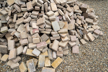 concrete paving repair, disassembled path folded by a pile of stones