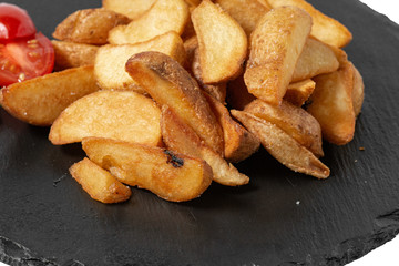 roasted potatoes on the blackboard. on white background