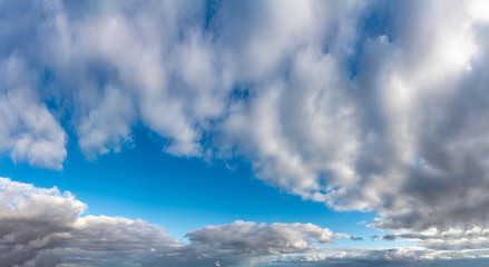 Fantastic clouds against blue sky, panorama