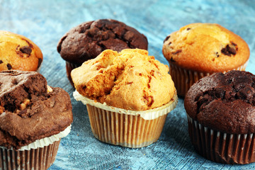 Chocolate muffin and nut muffin, homemade bakery on background.