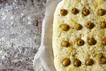 Italian focacca before baking. Yeast dough. Baking at home.