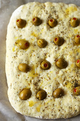 Italian focacca before baking. Yeast dough. Baking at home.