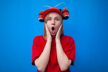 surprised funny girl fan in red uniform and beer hat looks at a place for text, shocked cheerleader is rooting for the team