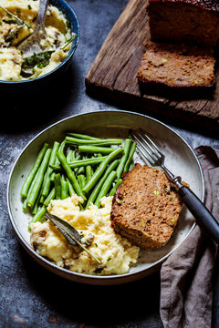Plate of mashed potatoes with green beans and meat loaf