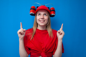 happy funny girl fan in red uniform and beer hat looks shows thumbs up