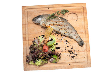 grilled fish with vegetables on a white background