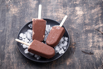 Chocolate ice cream popsicles in glaze