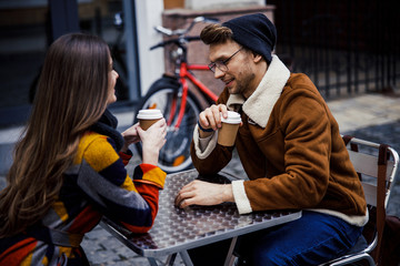 Two people enjoying coffee outdoors on autumn day stock photo