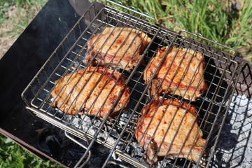 Pork steaks cooked on a charcoal grill outdoors