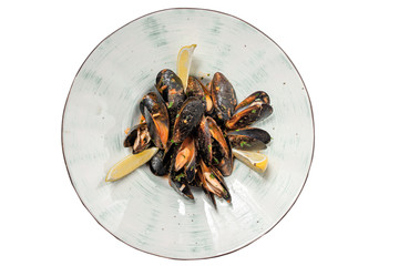 mussels with lemon on a plate on a white background