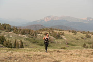 female traveler and photographer hiking in the mountains of Colorado