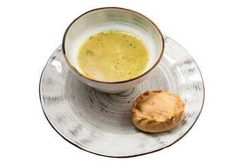 broth with a pie on a white background