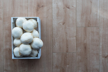 Mushroom box on wooden surface. top view. Copy-space.