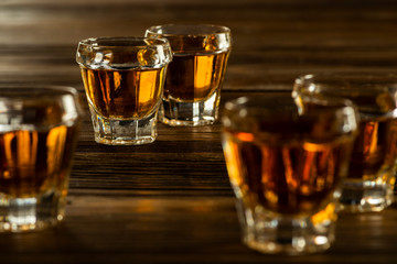 whiskey in shots on a wooden table, alcoholic beverages drinks