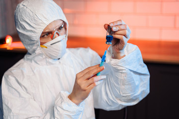 Coronavirus vaccine development. Scientific and medical lab instrument for biochemistry laboratory research. Chemist is analyzing sample in laboratory with chemical fluid syringe